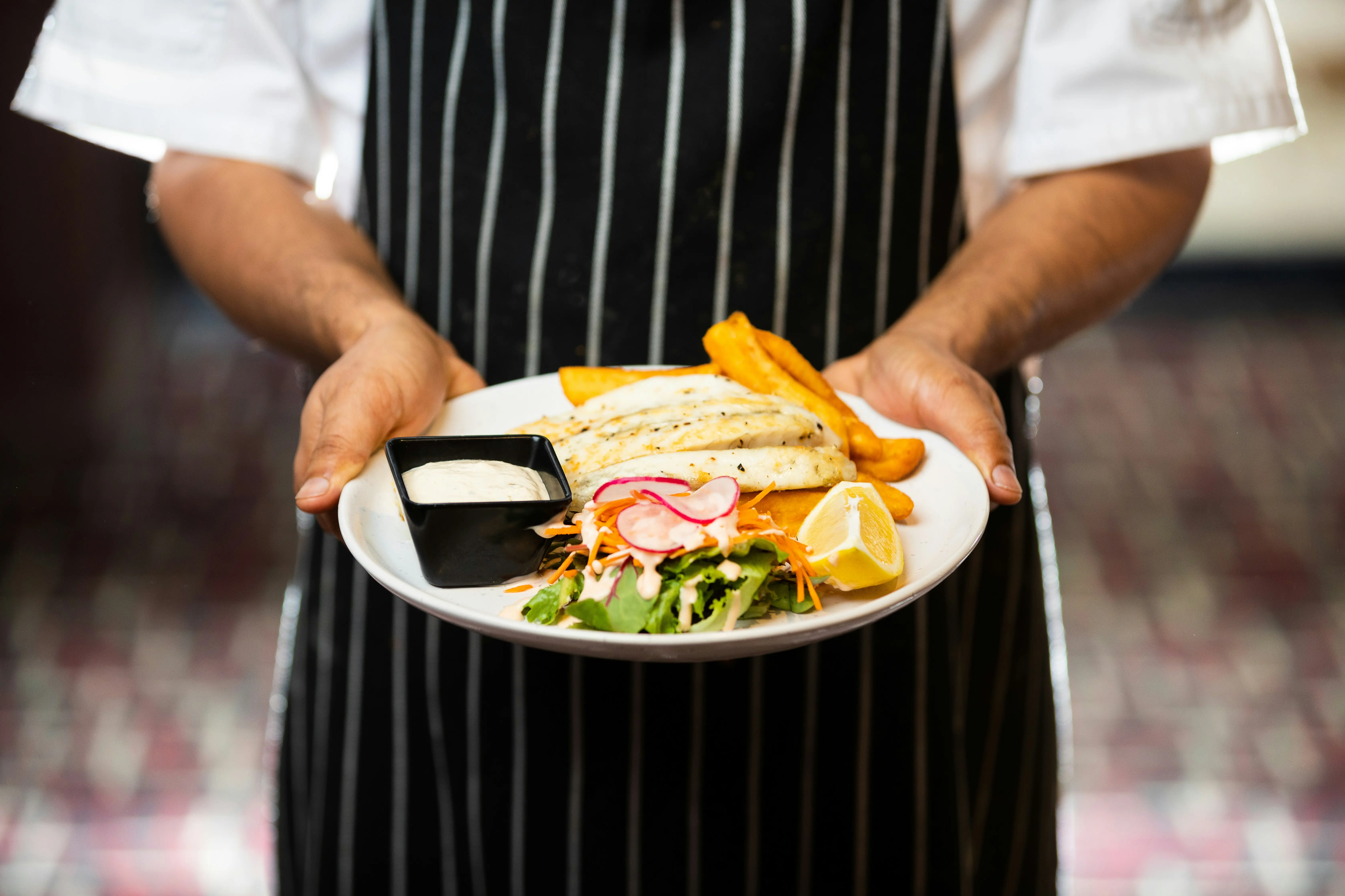Professional chef preparing gourmet dishes at Dineo restaurant in Morocco